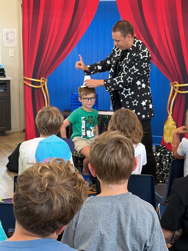Children enjoying a magic show at Amaze Academy